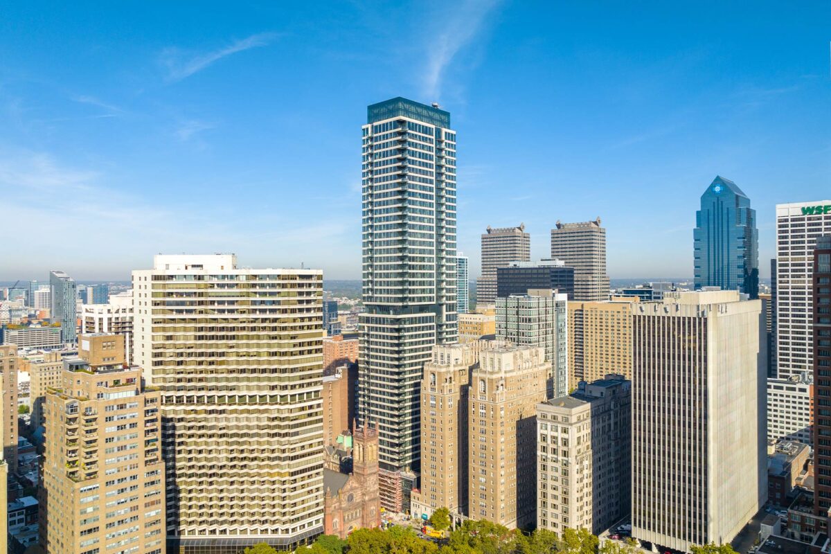 Aerial view of The Laurel tower with its glass facade, rising above Philadelphia’s skyline near Rittenhouse Square.