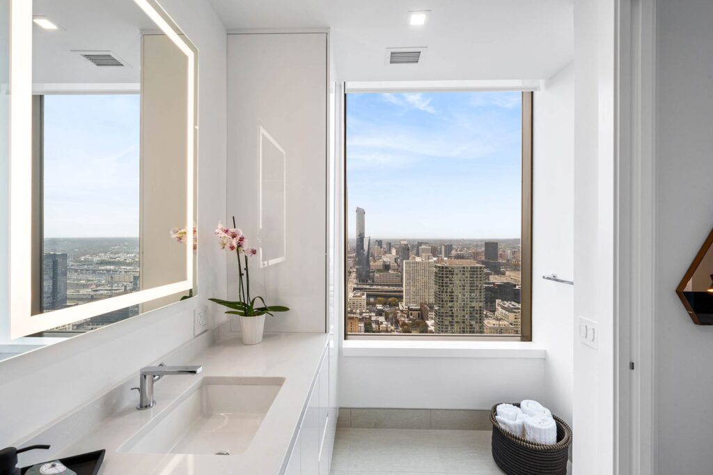 Modern bathroom with a window overlooking the city.