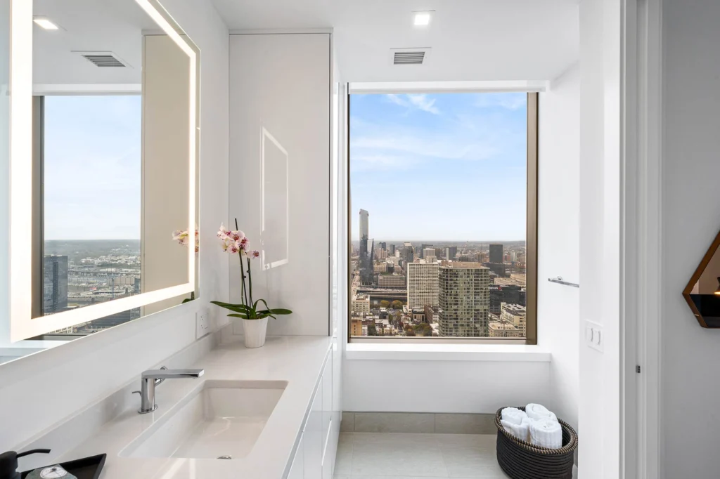 Modern bathroom with a window overlooking the city.